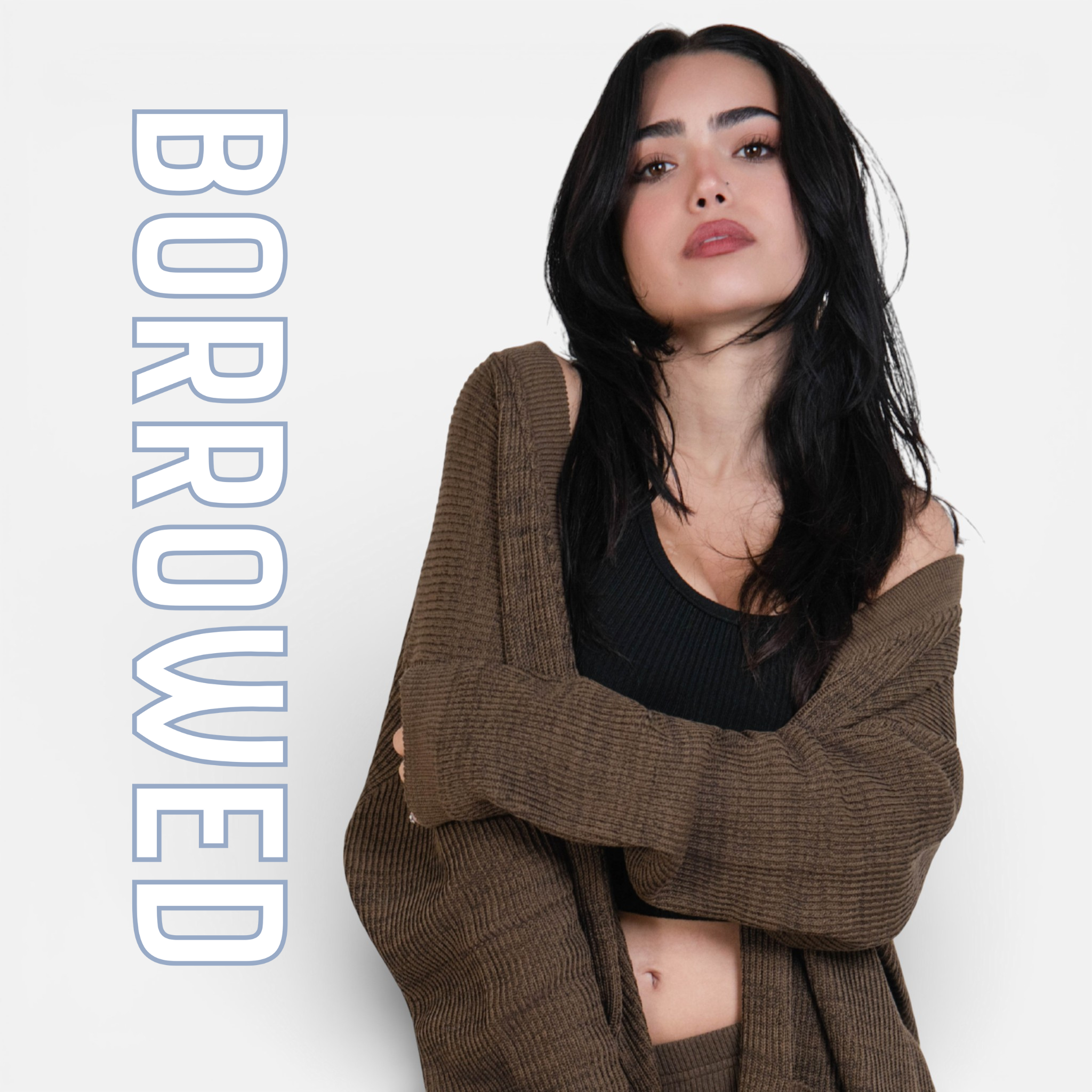 girl wearing brown cardigan with a black tank with the word Borrowed next to her