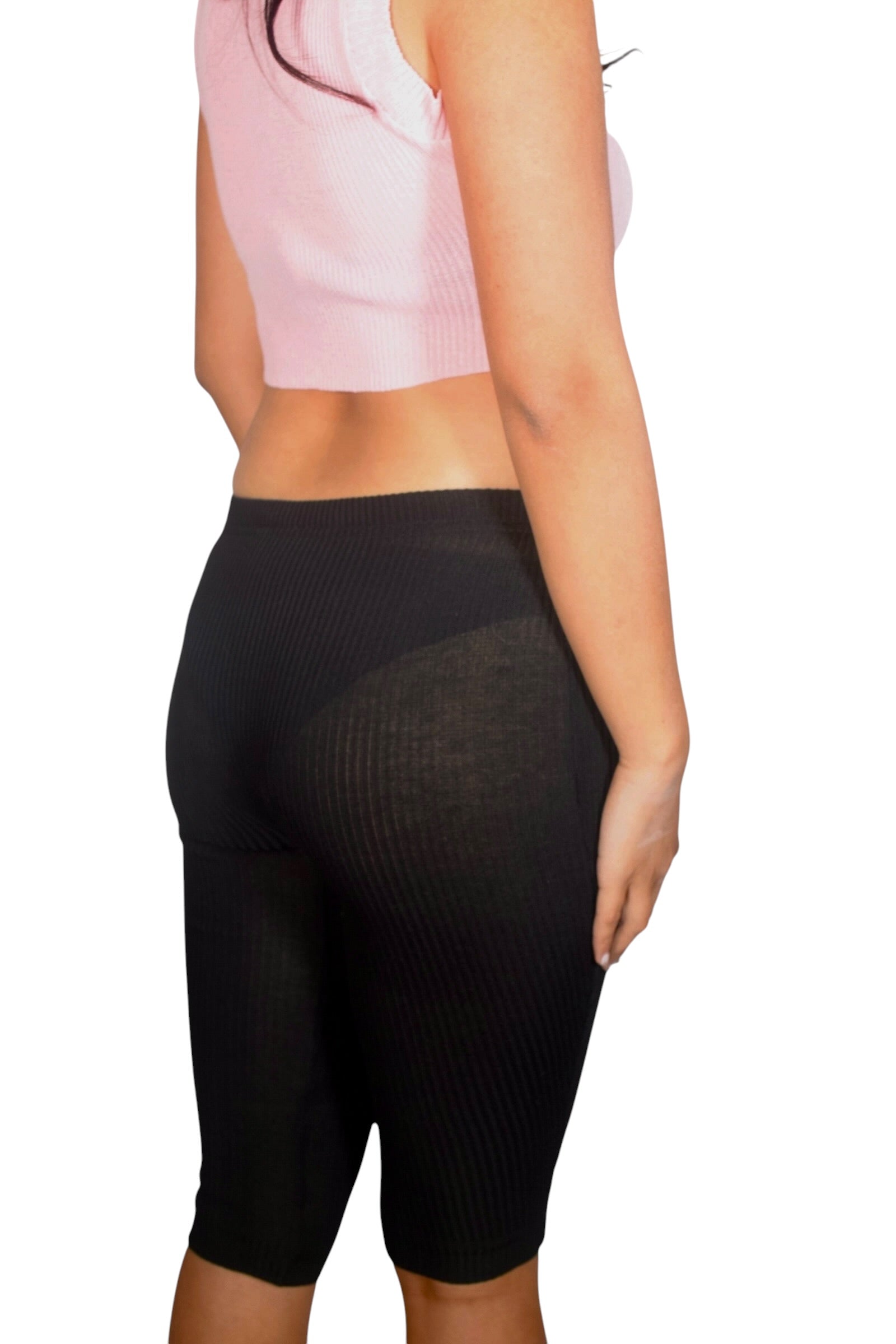 Person wearing black high-waisted leggings on a white background