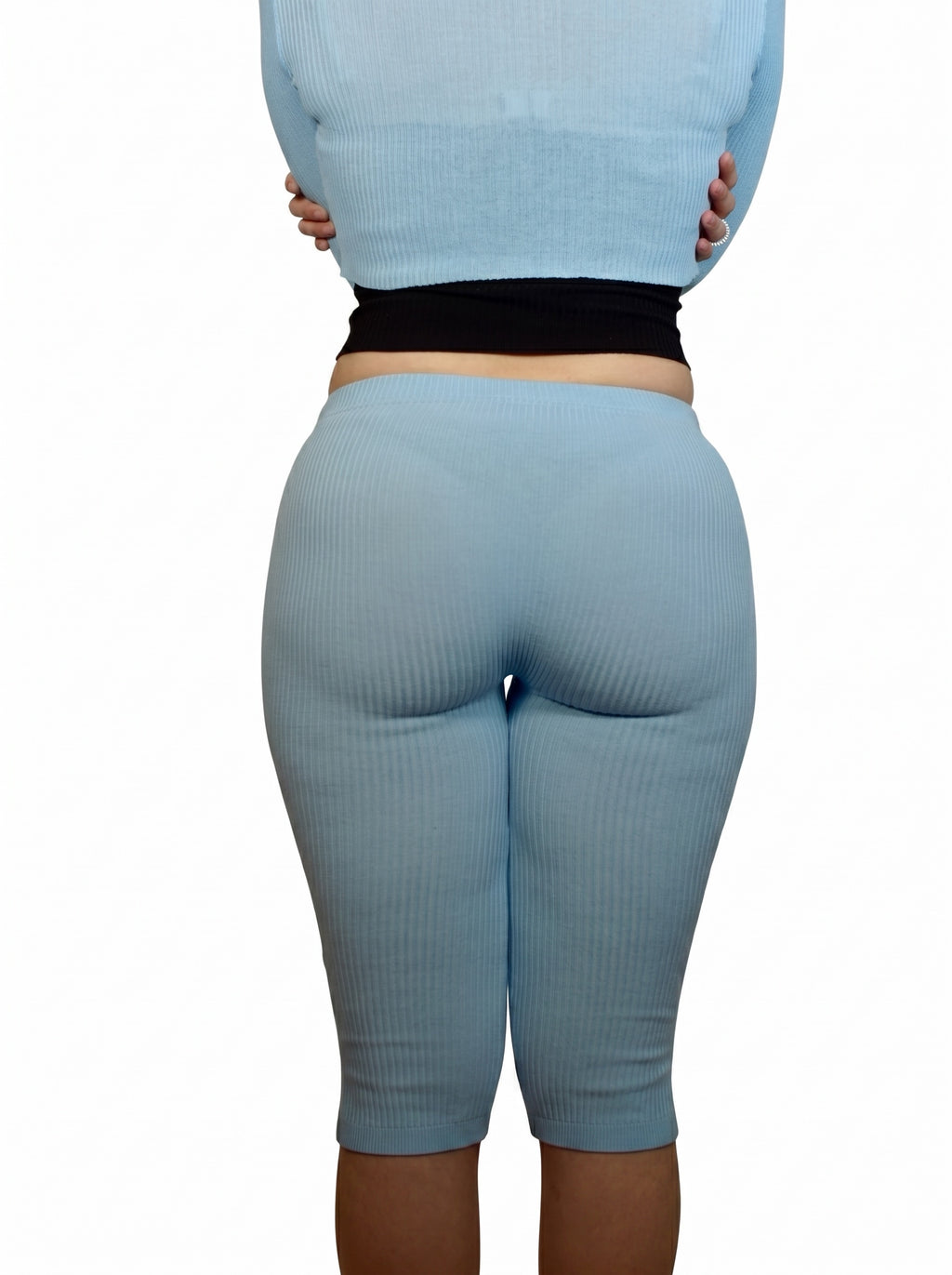 Light blue leggings worn by a person on a white background