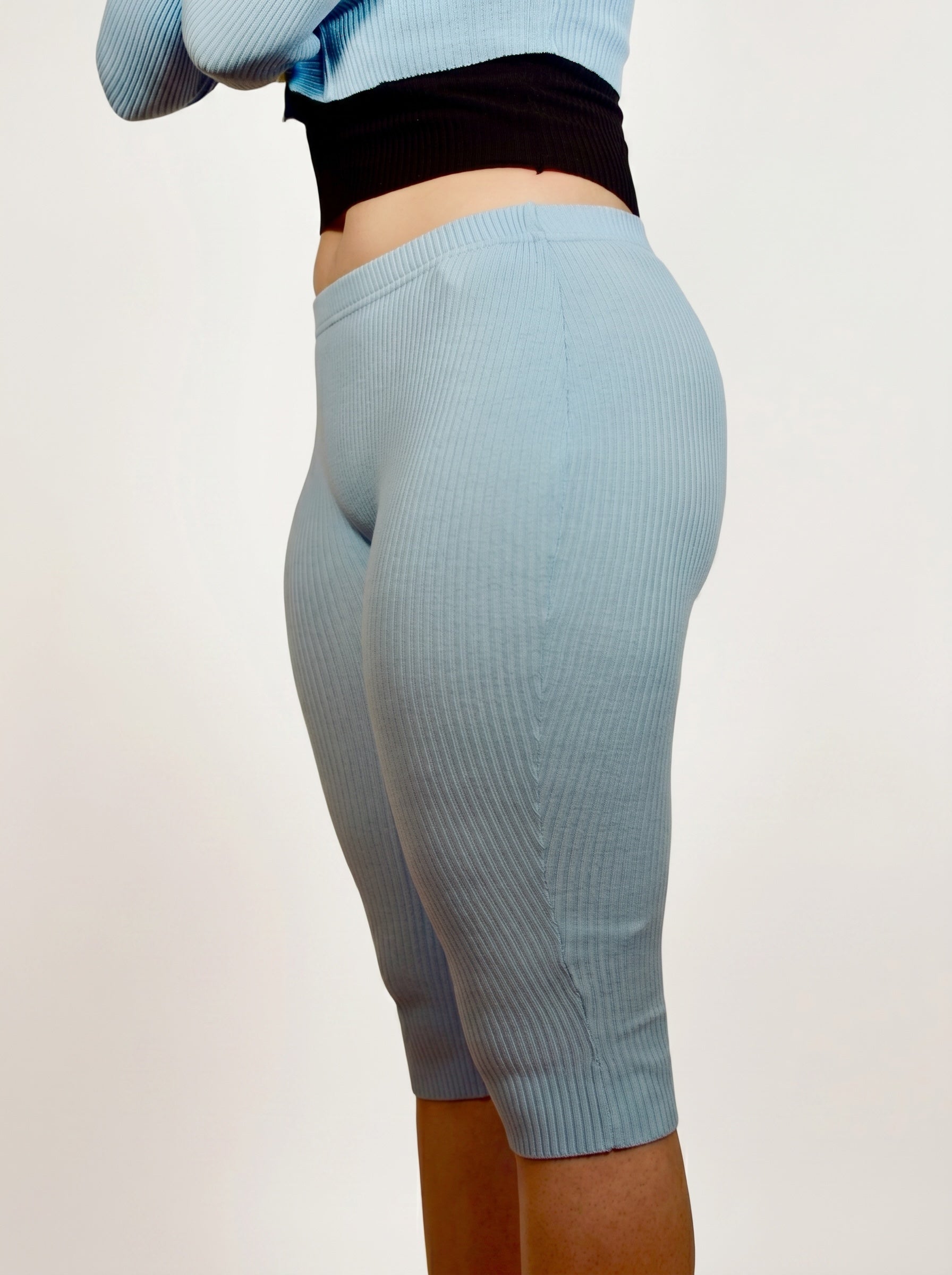 Light blue ribbed leggings worn by a person on a plain background