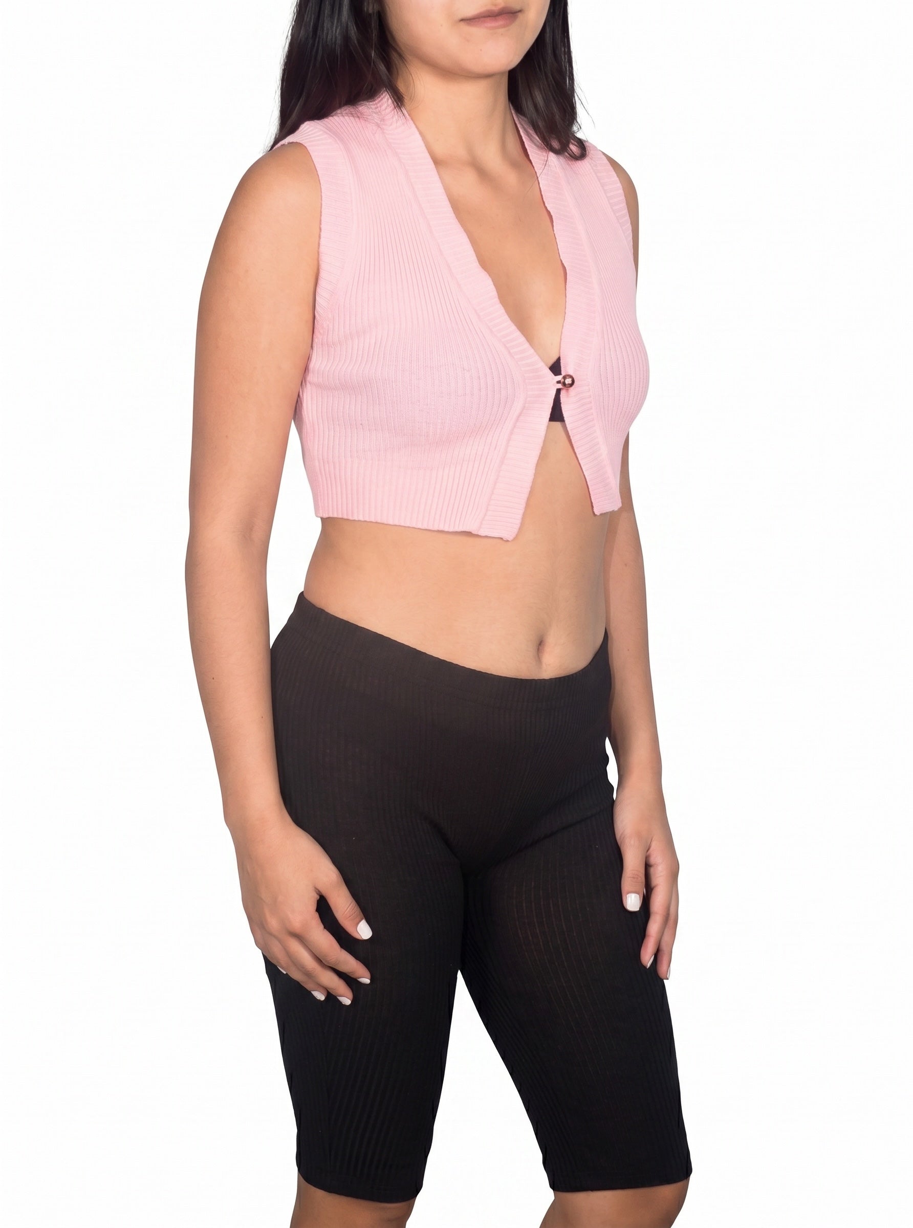 Person wearing a pink sleeveless top and black leggings on a white background