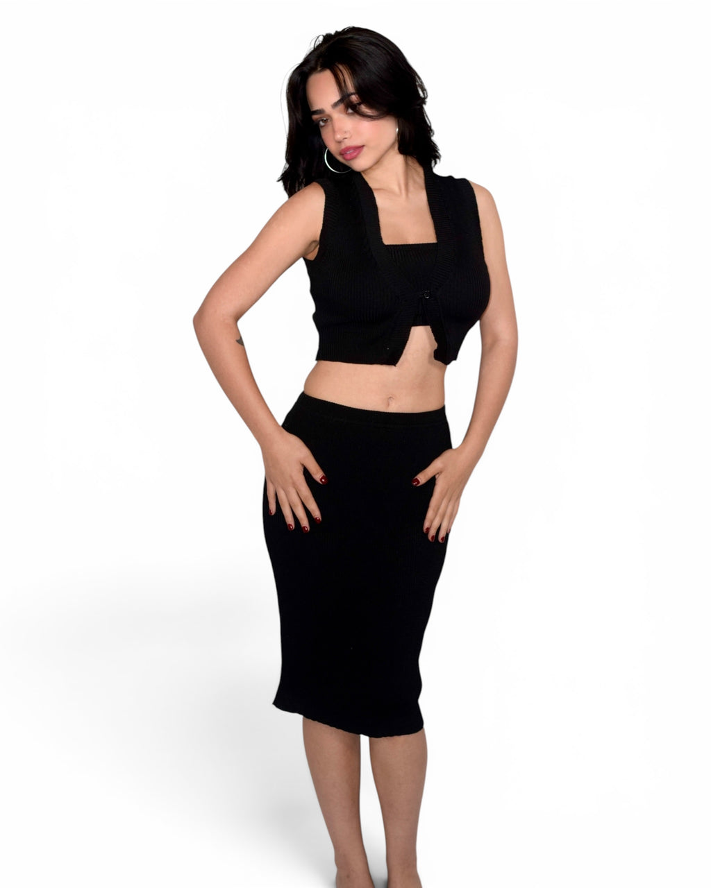 Woman wearing a black sleeveless top and skirt on a white background