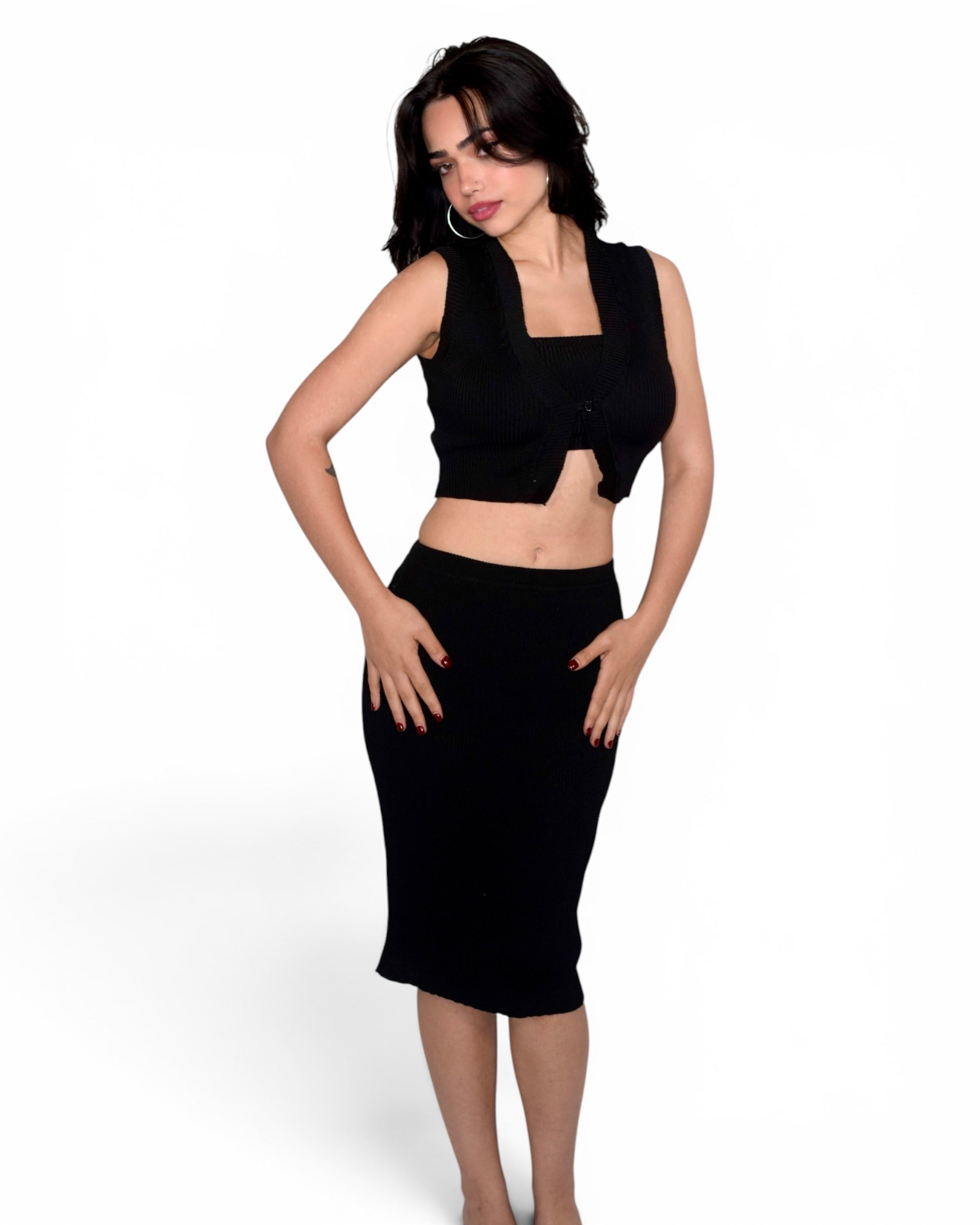 Woman wearing a black sleeveless top and skirt on a white background
