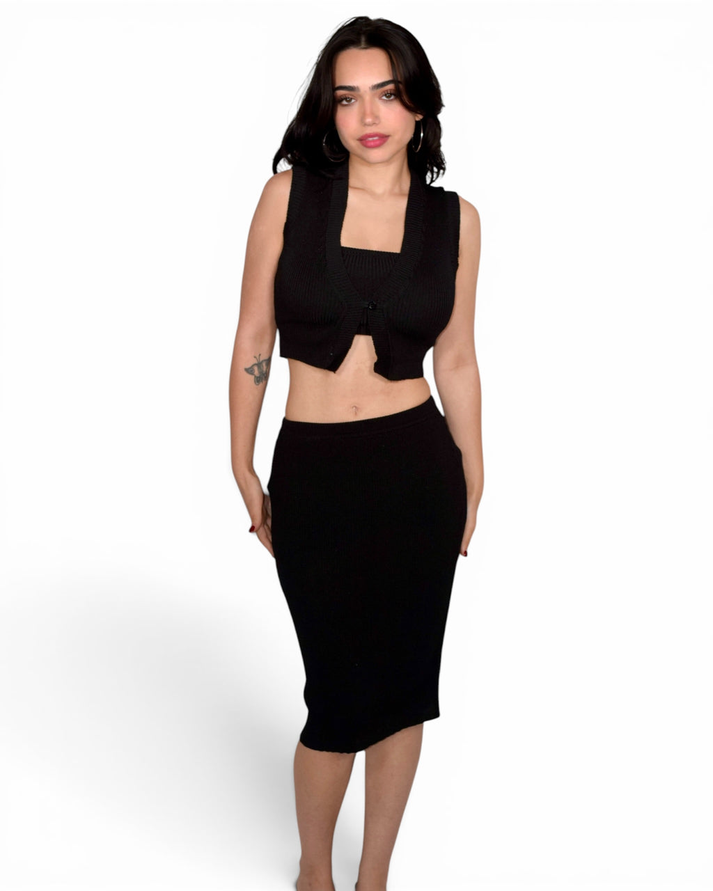 Woman wearing a black sleeveless top and skirt on a white background