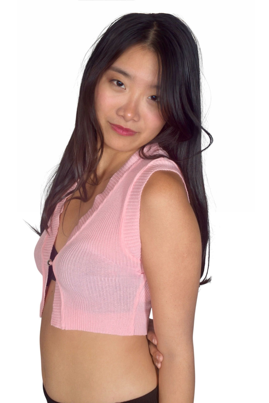 Woman wearing a pink sleeveless top on a white background