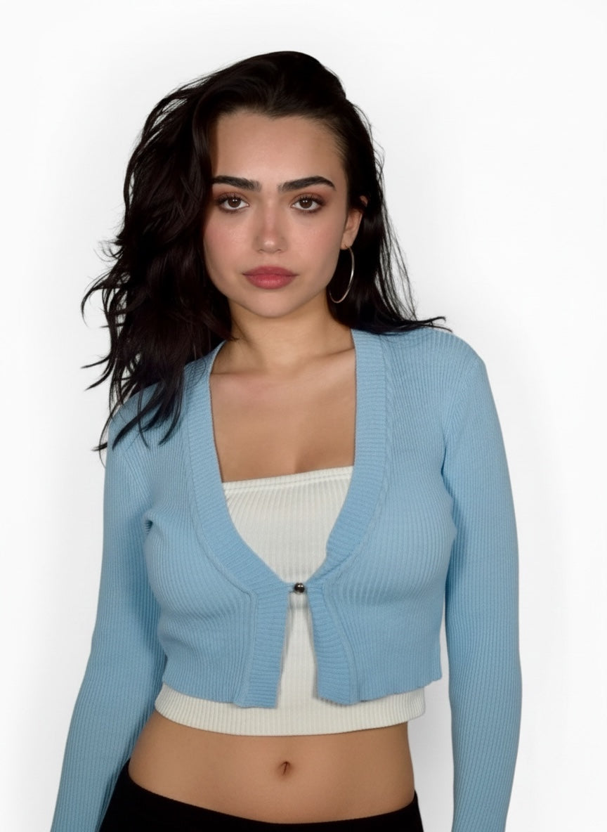 Woman wearing a light blue cardigan over a white top on a white background
