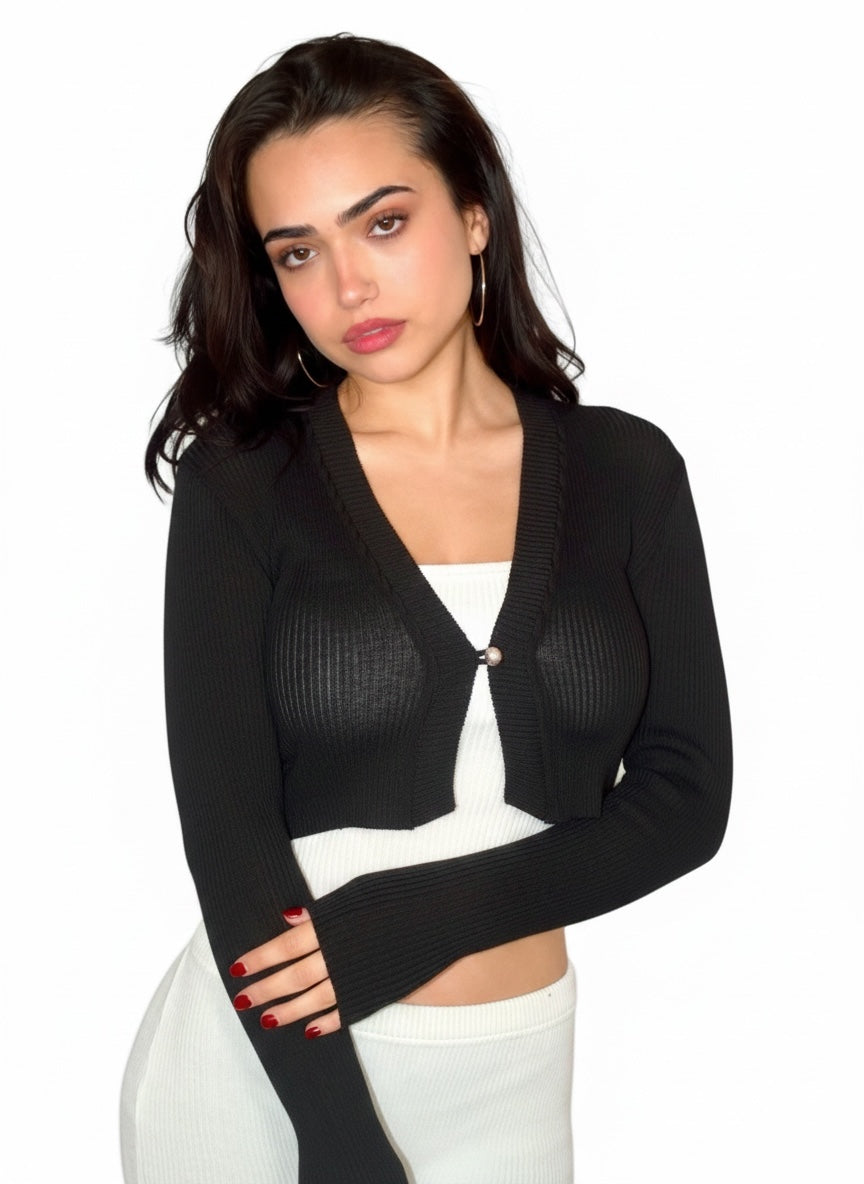 Woman wearing a black cardigan over a white top on a white background