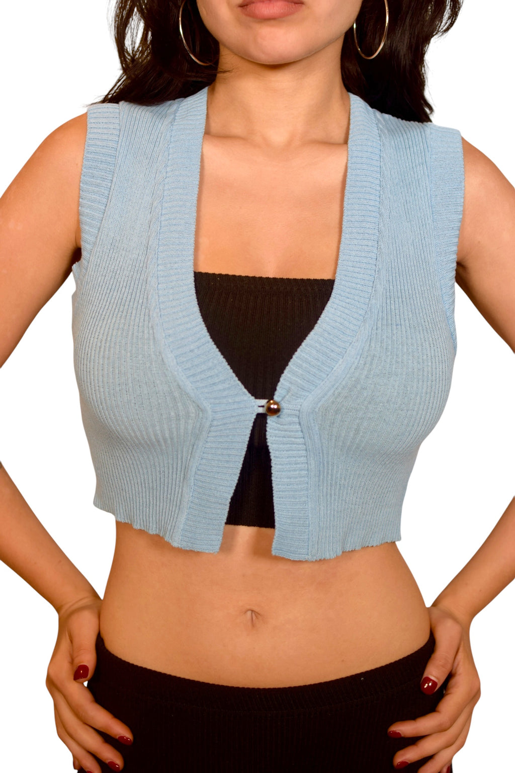 Light blue sleeveless knit vest over a black top on a white background