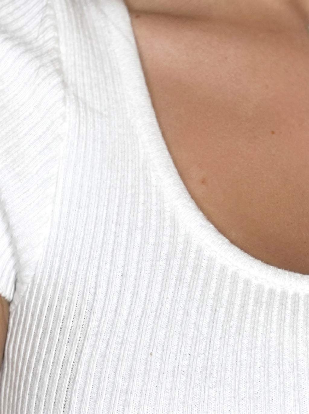 Close up of rib knit neckline and bust knit by TKHLA 