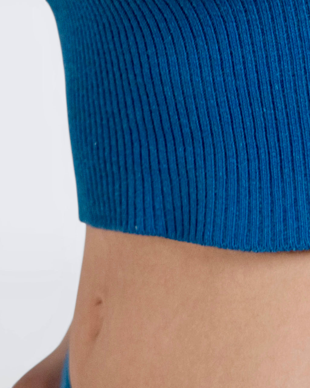 close up of mideriff wearing cobalt blue rib crop tank