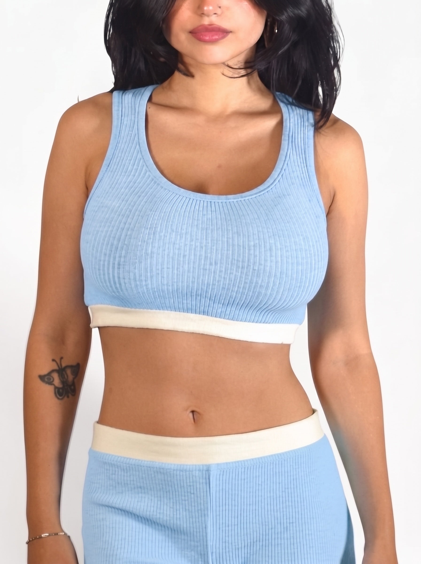 Person wearing soft blue rib knit crop tank and short w white bands by TKHLA