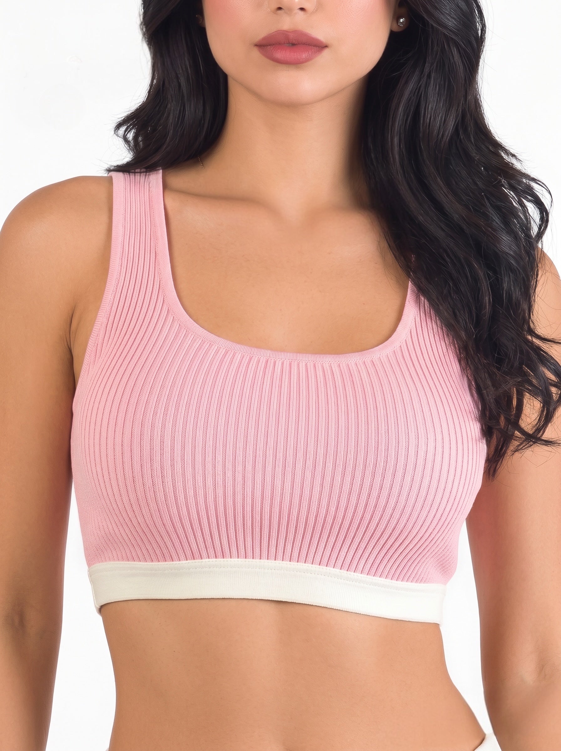 Woman wearing pink crop tank with white band by TKHLA