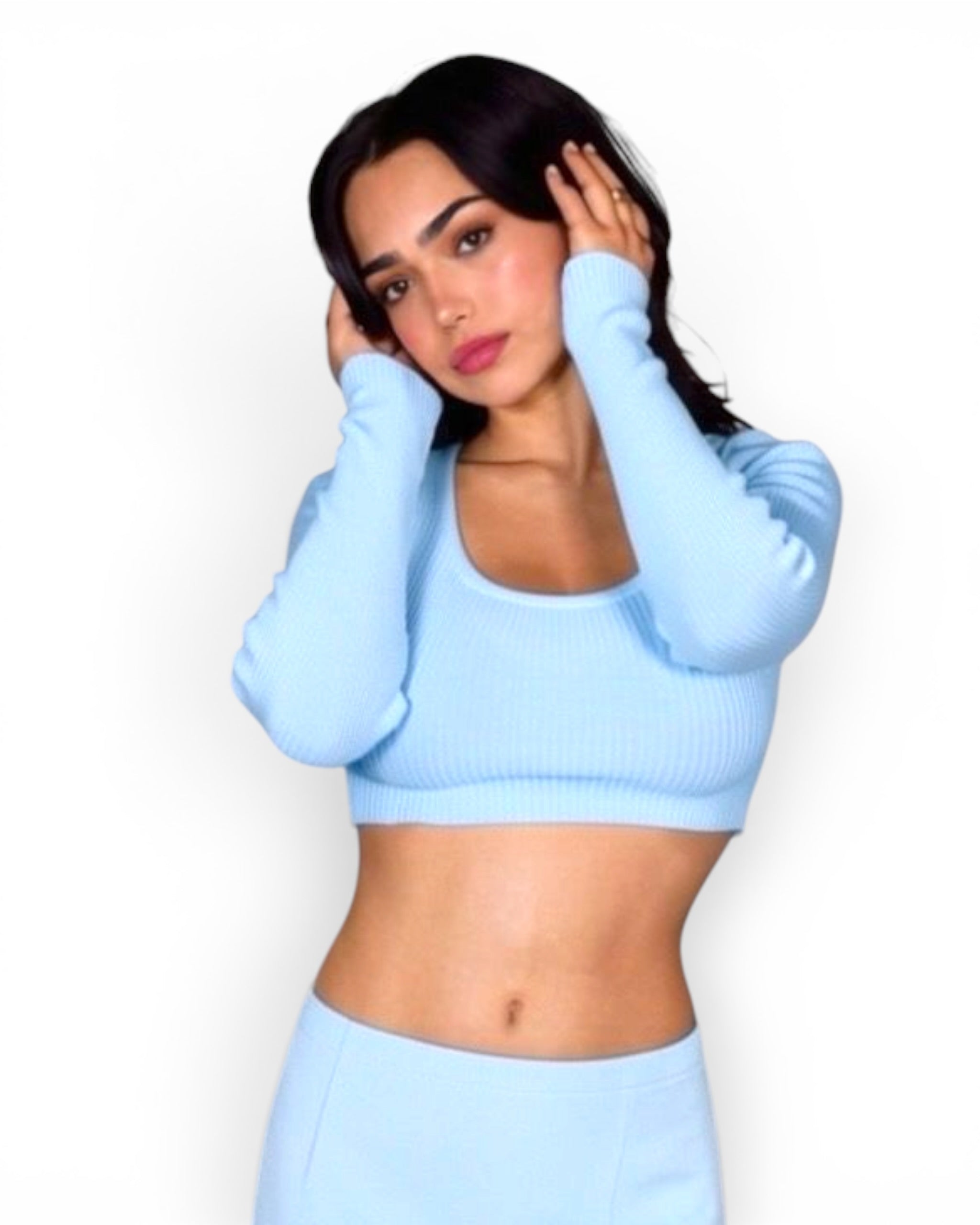 Woman wearing a light blue outfit against a white background