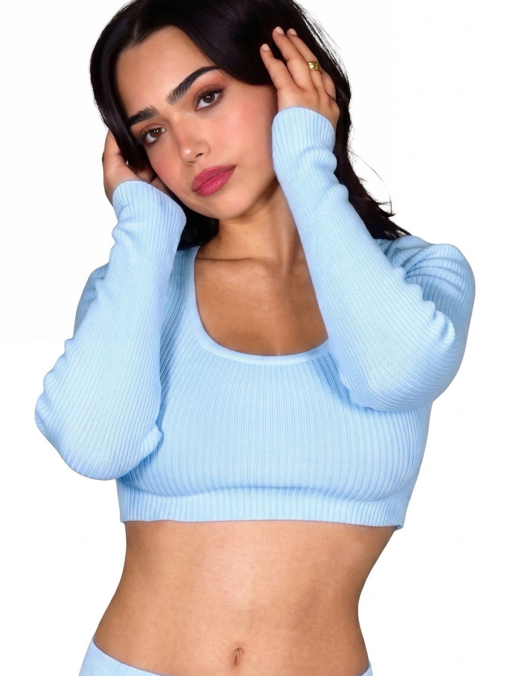 Woman wearing soft blue long sleeve crop top by TKHLA