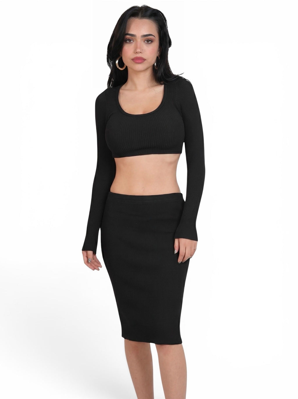 Woman wearing matching black rib knit crop long sleeve scoop neck top and pencil skirt by TKHLA 