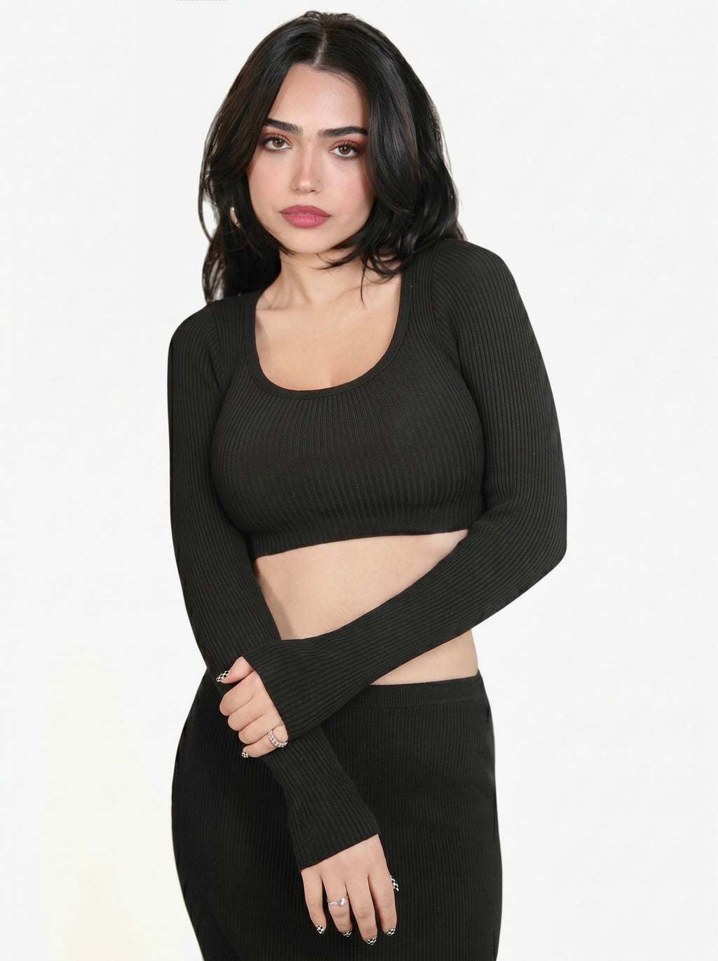 Woman wearing black rib knit crop long sleeve scoop neck top and pencil skirt by TKHLA 
