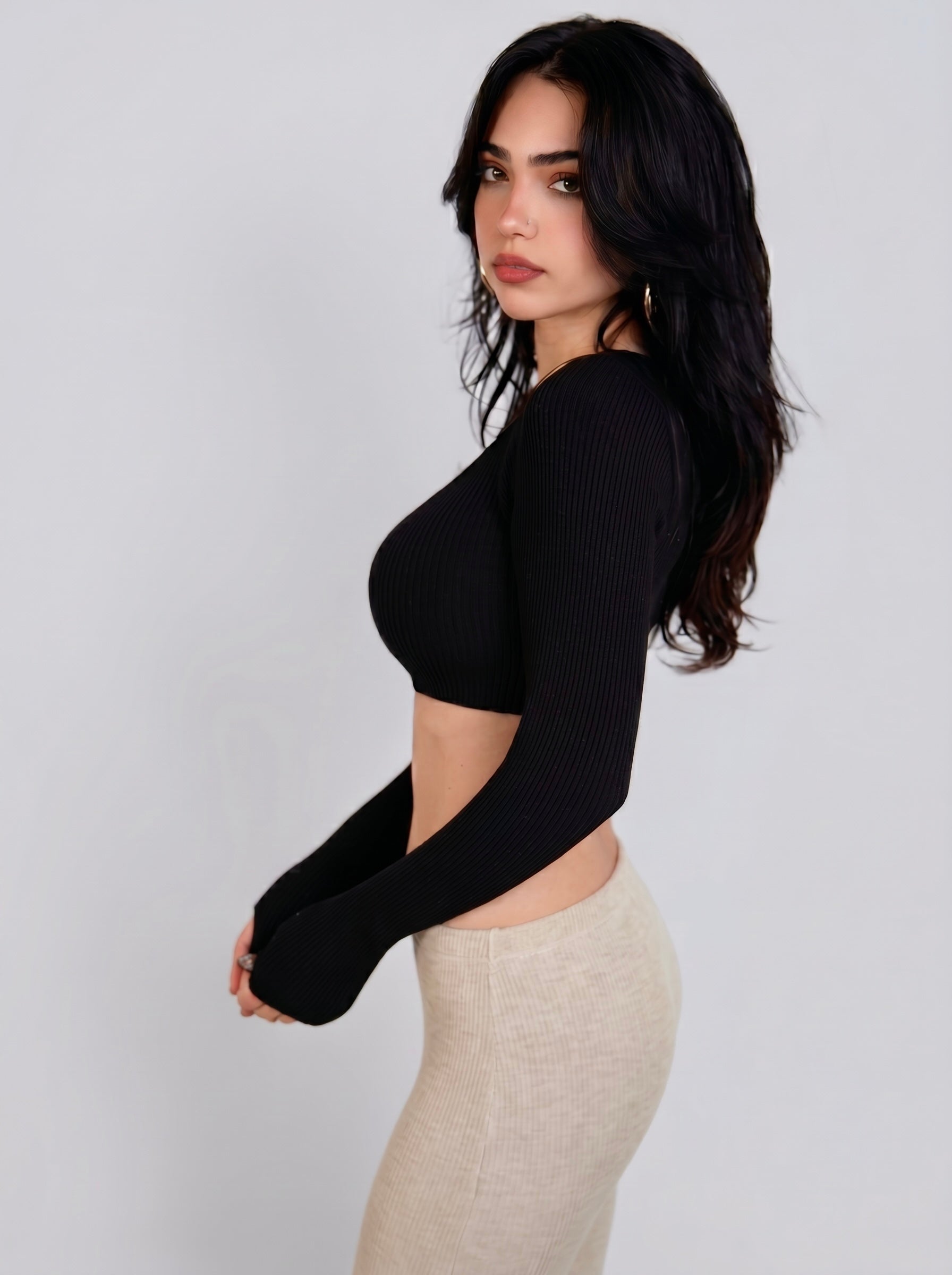 Woman wearing black rib knit crop long sleeve top and beige Capri by TKHLA 