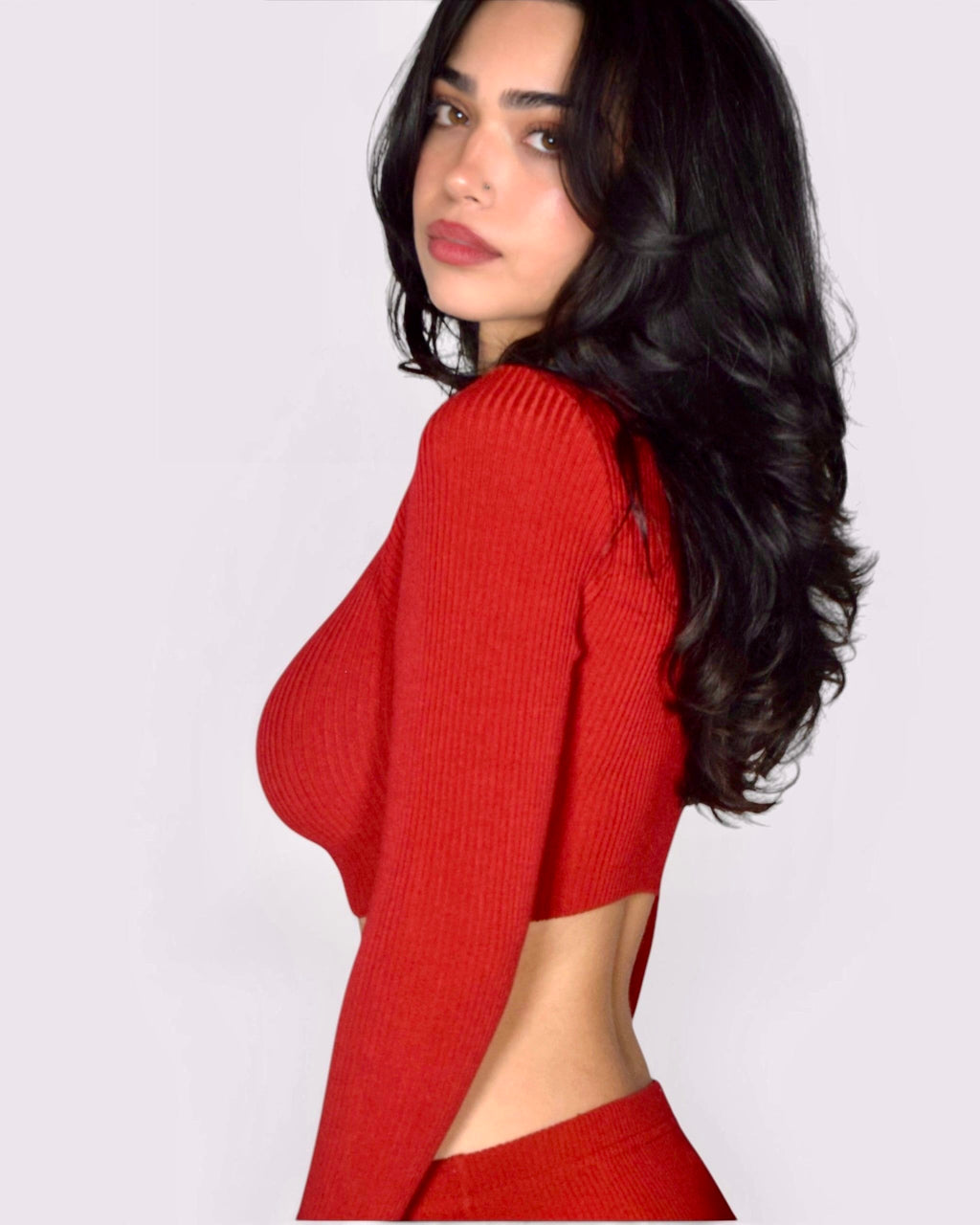 Woman wearing long sleeve crop top in red rib knit by The Knit House LA