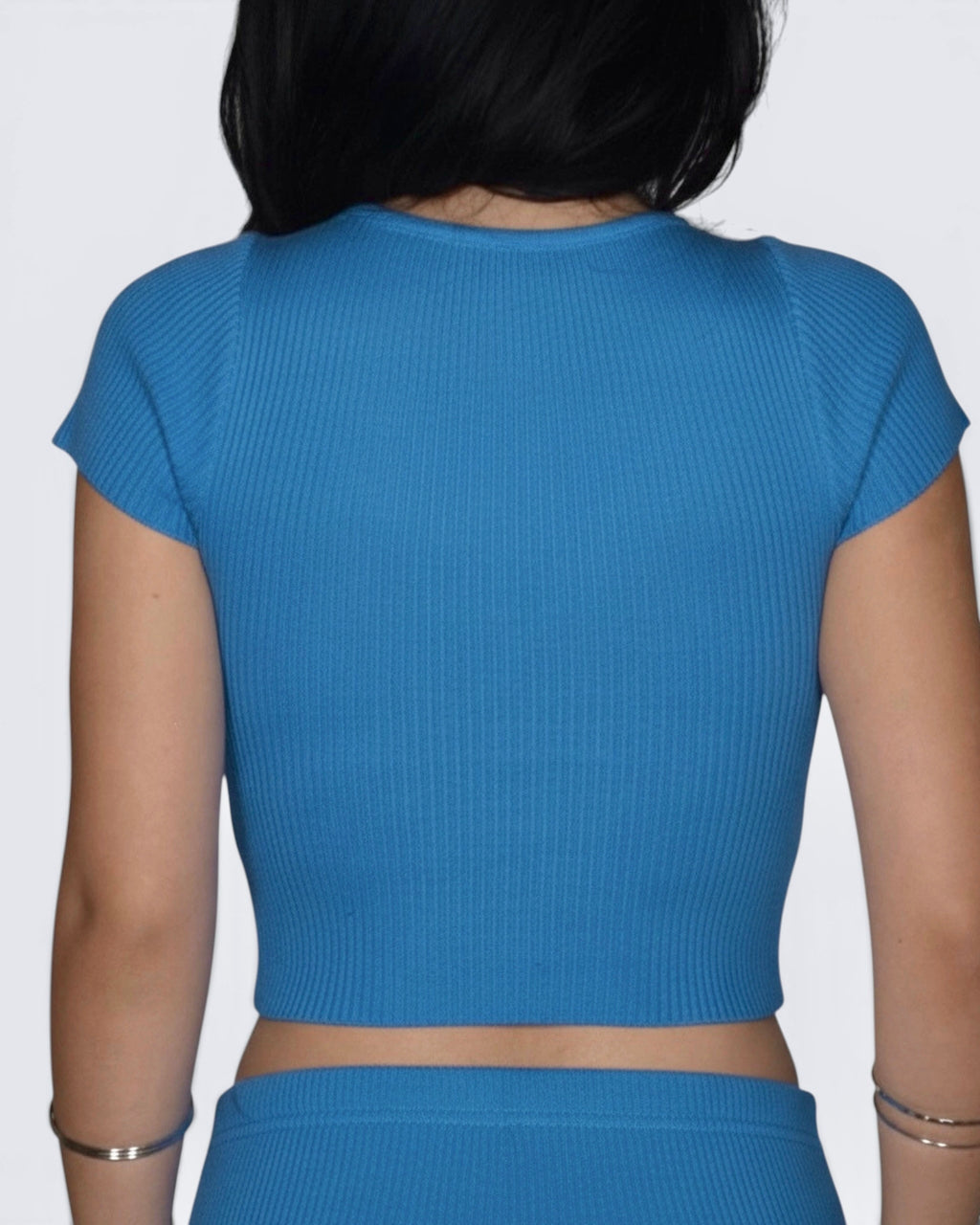 Back view of crop cobalt ribbed short sleeve top