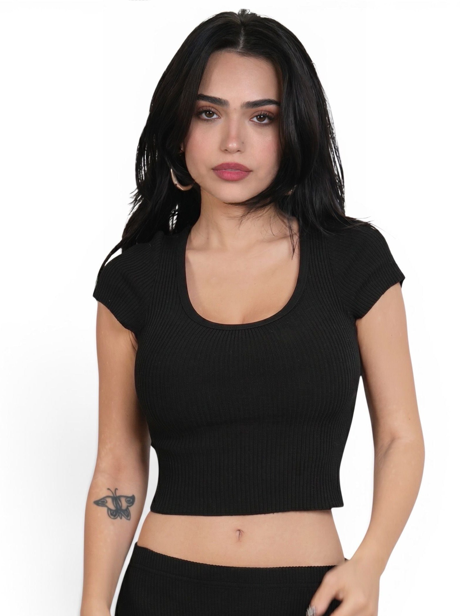 Woman wearing black rib knit crop short sleeve scoop neck top by TKHLA 