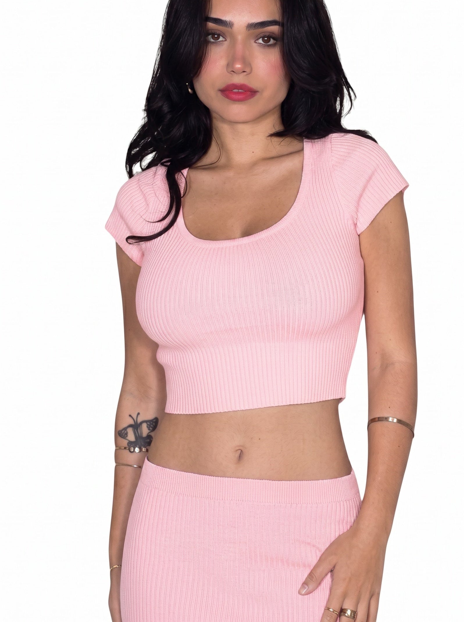 Woman wearing matching pink rib knit crop top and pencil skirt by TKHLA