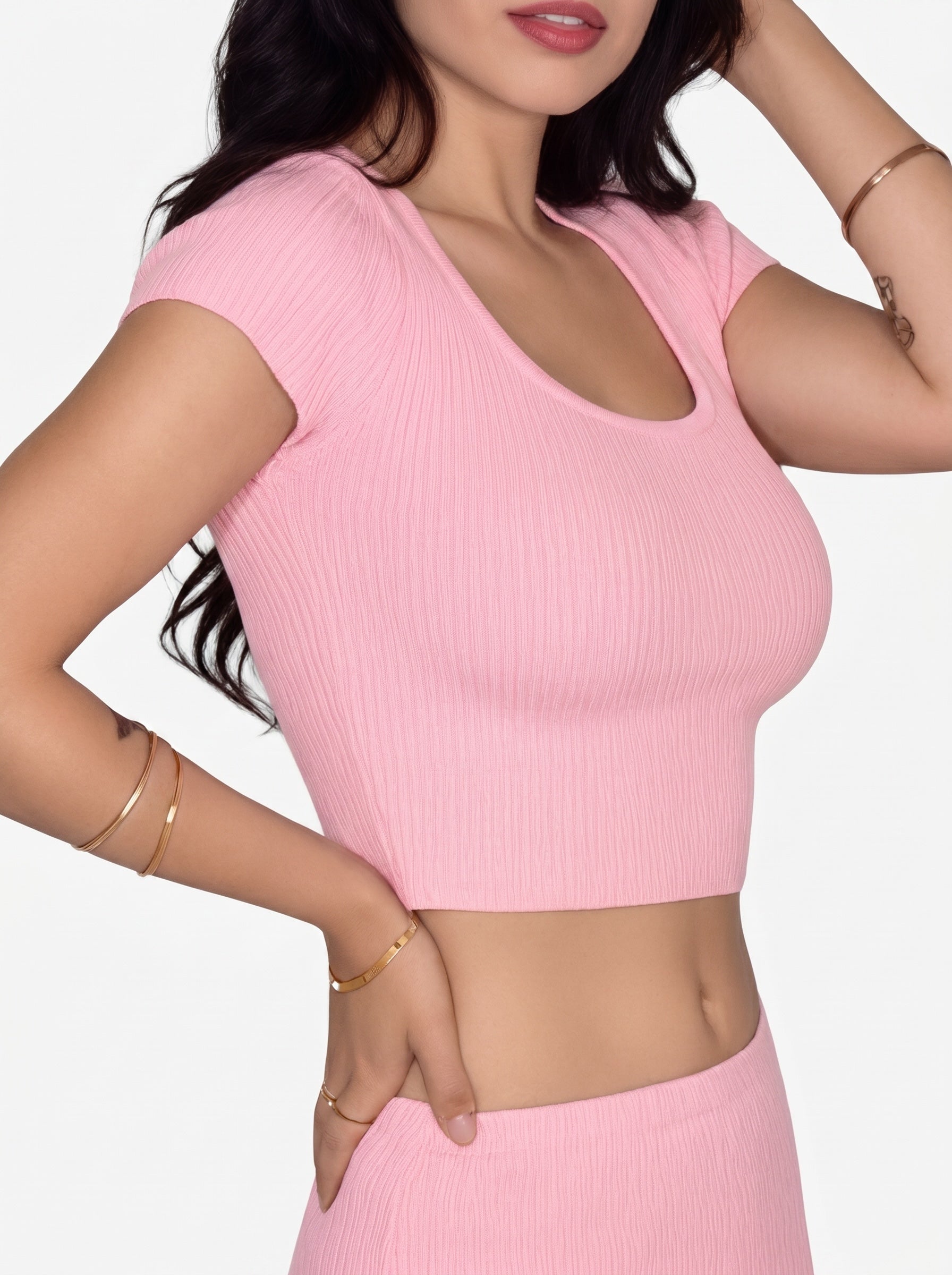 Side view of person wearing pink rib knit short sleeve scoop neck top and skirt by TKHLA