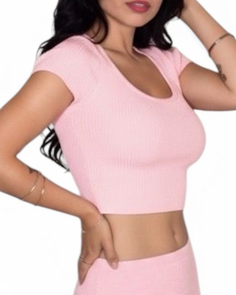 Woman wearing a pink crop top on a white background