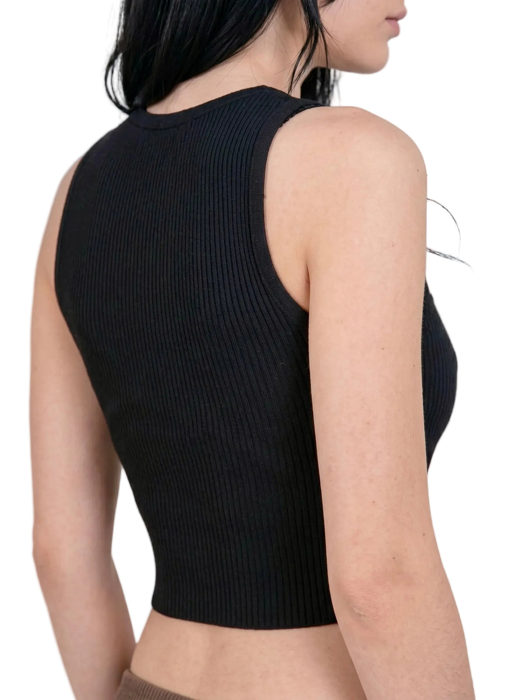 Back view of person wearing crop rib knit black tank by TKHLA 