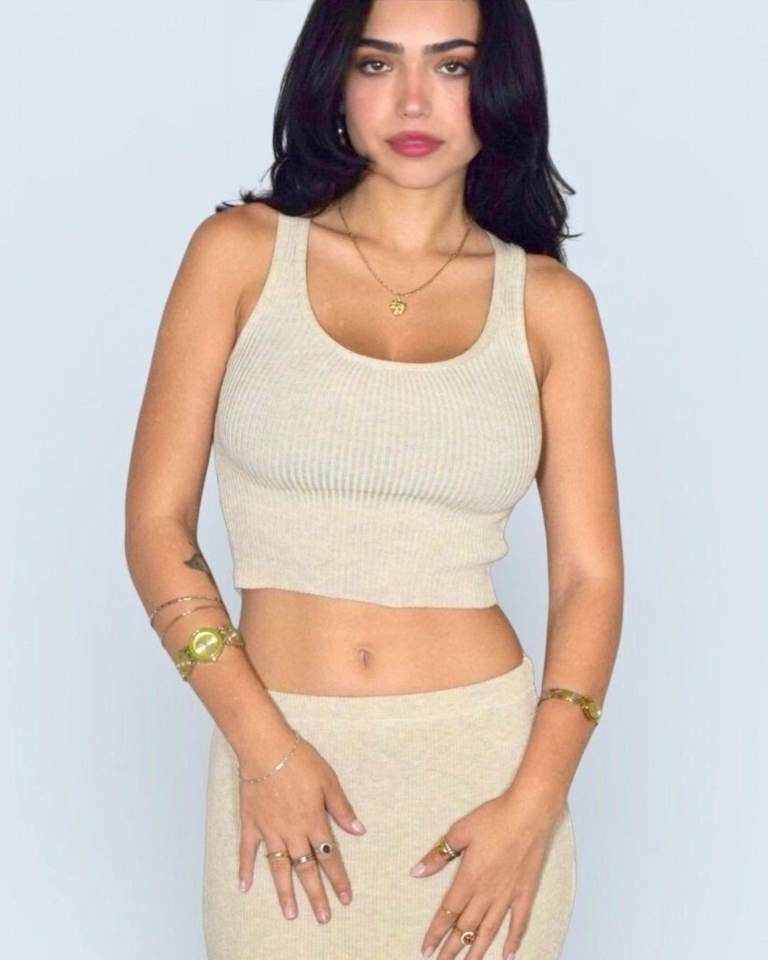 Woman wearing beige scoop neck crop tank and skirt by The Knit House LA. 