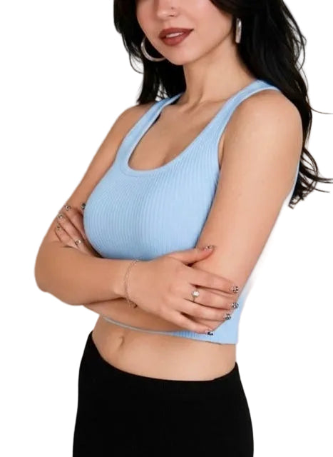 Woman wearing a light blue tank top with a plain background