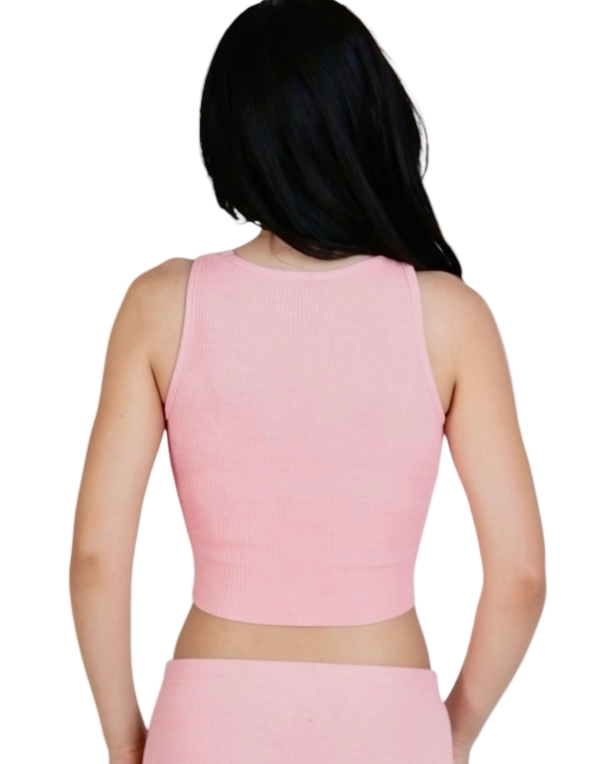 Person wearing a pink sleeveless top and skirt set on a plain background