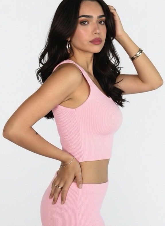 Woman wearing a pink dress against a white background