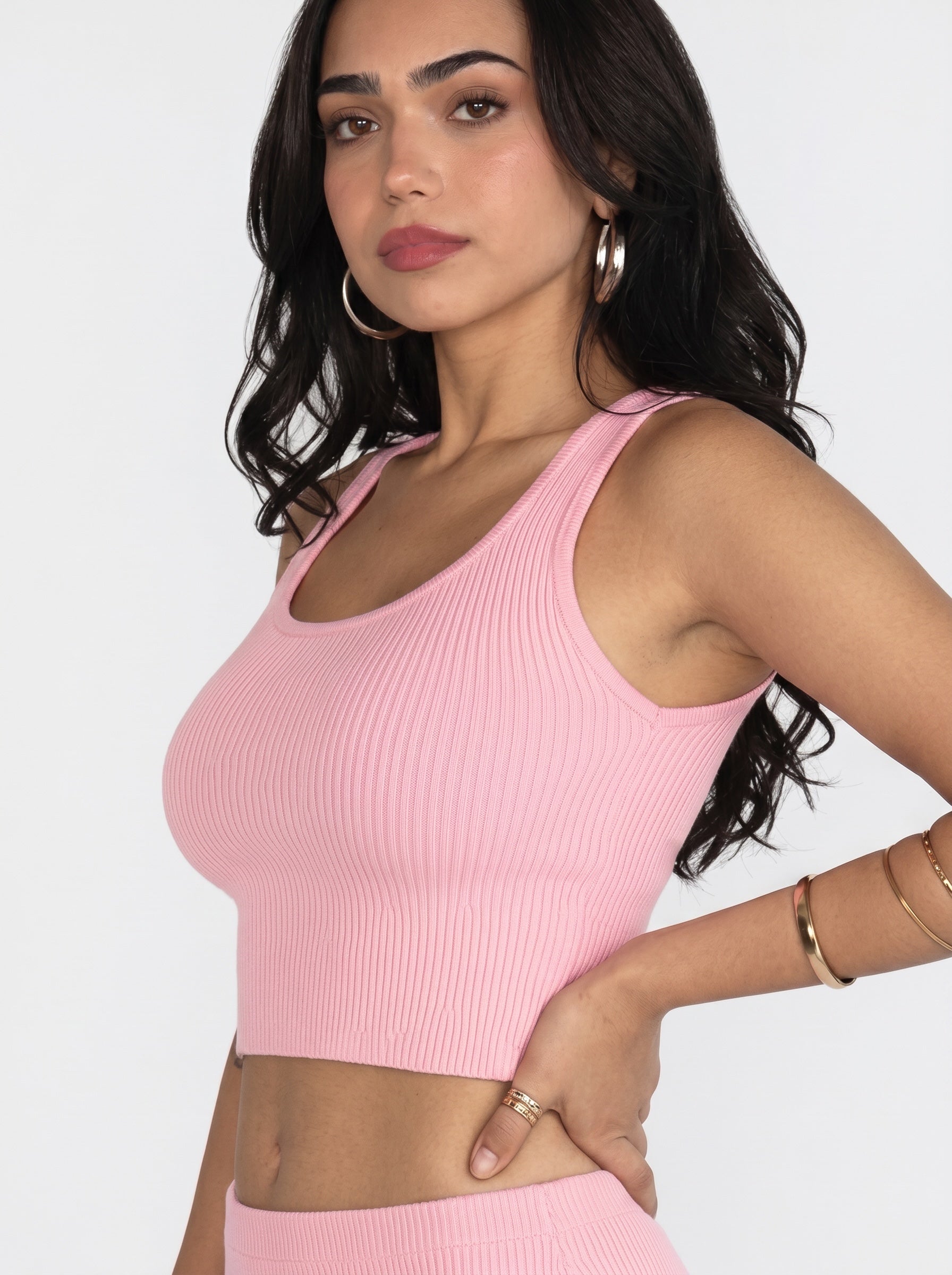 Woman wearing soft pink rib knit crop scoop neck tank and skirt by TKHLA