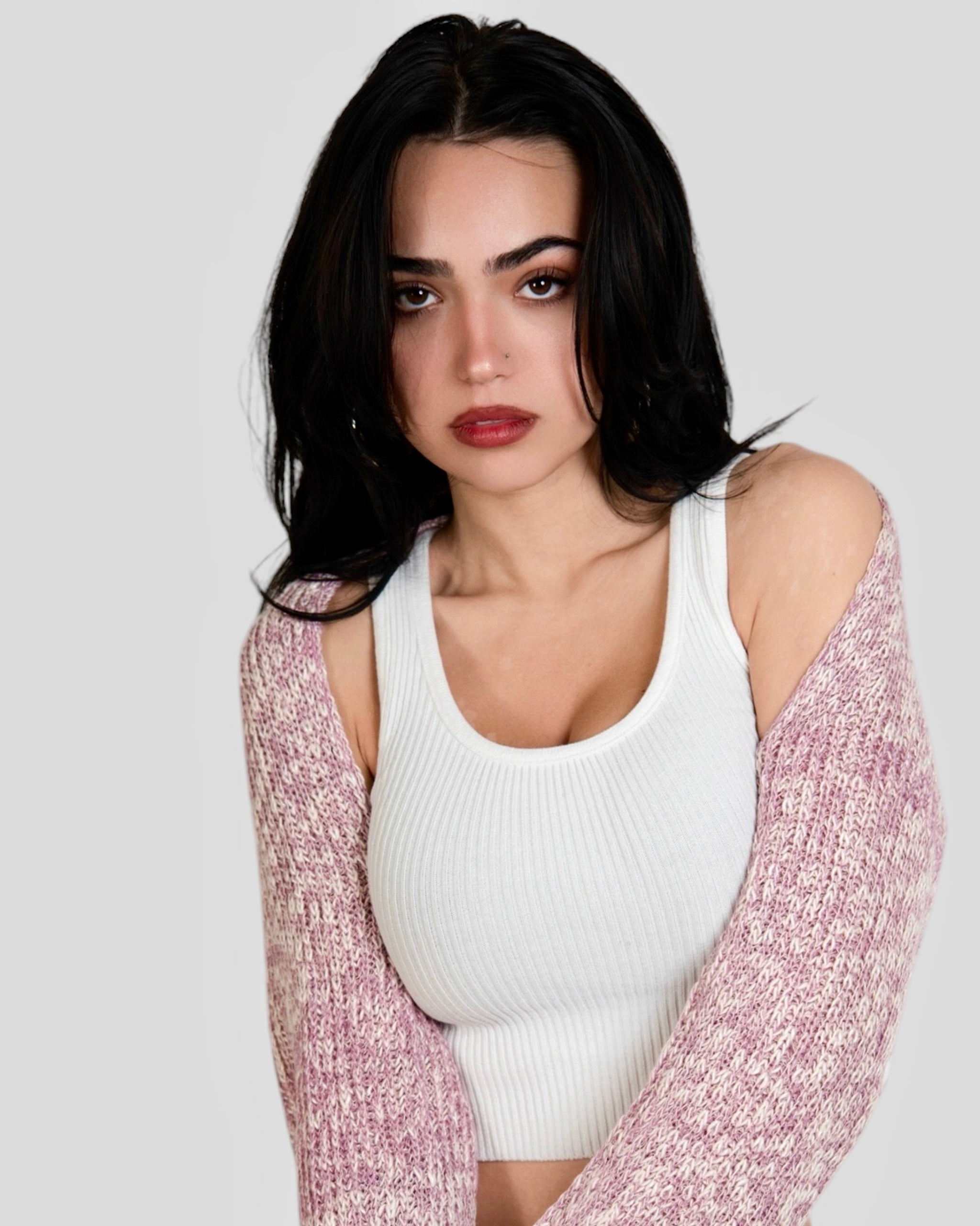 Woman wearing white scoop neck crop tank with a pink knit shrug by The Knit House LA. 