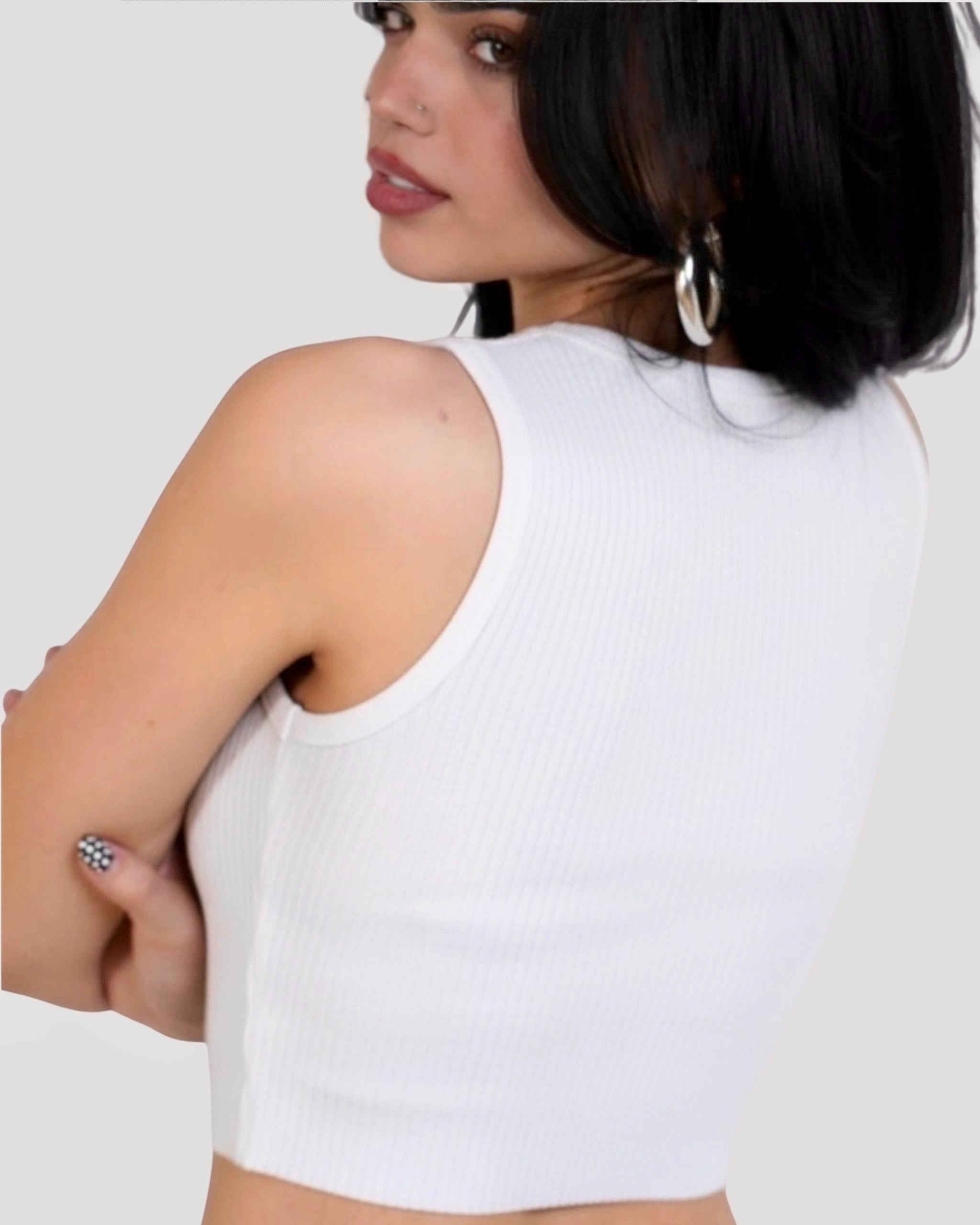 Back view of Woman wearing white crop tank in rib knit by The Knit House LA