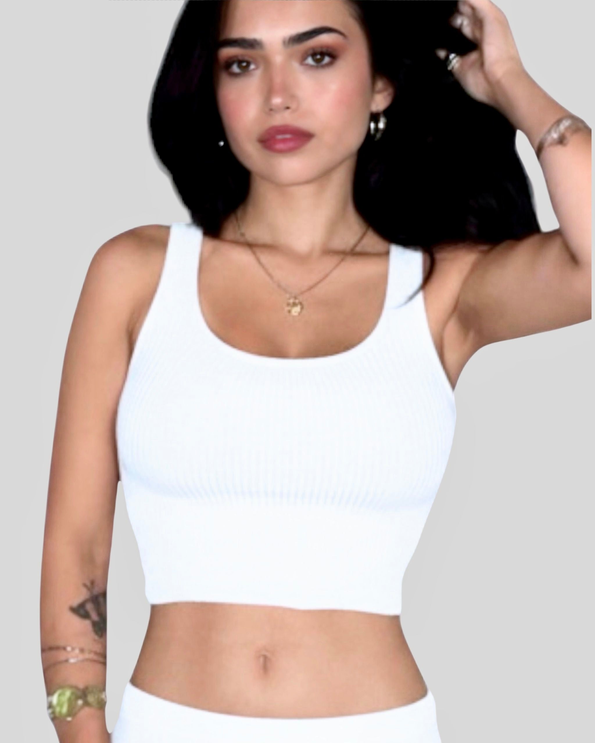 Woman wearing white scoop neck crop rib knit tank and skirt by The Knit House LA