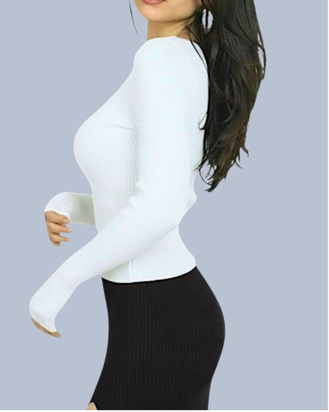 Woman wearing a white long-sleeve scoop-neck top and black ribbed skirt on a light gray background