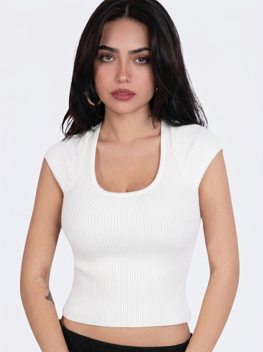 Woman wearing white rib knit scoop neck short sleeve top by TKHLA 