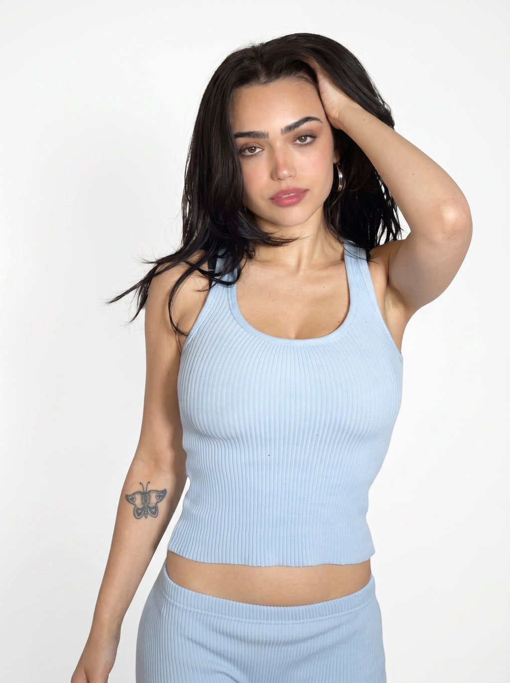 Woman wearing blue rib knit scoop neck tank w matching blue Capri by TKHLA