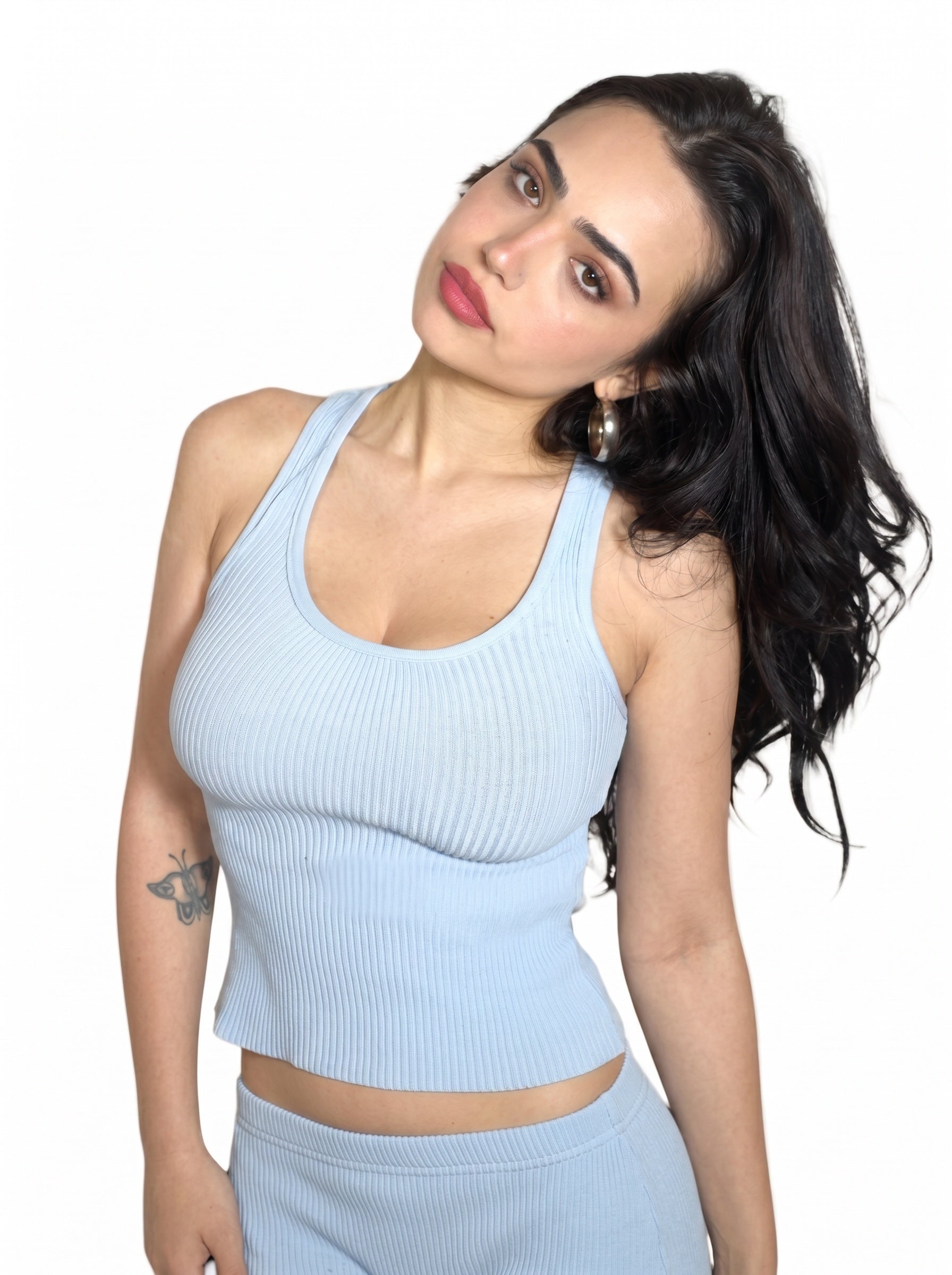 Woman wearing blue rib tank and Capri by TKHLA