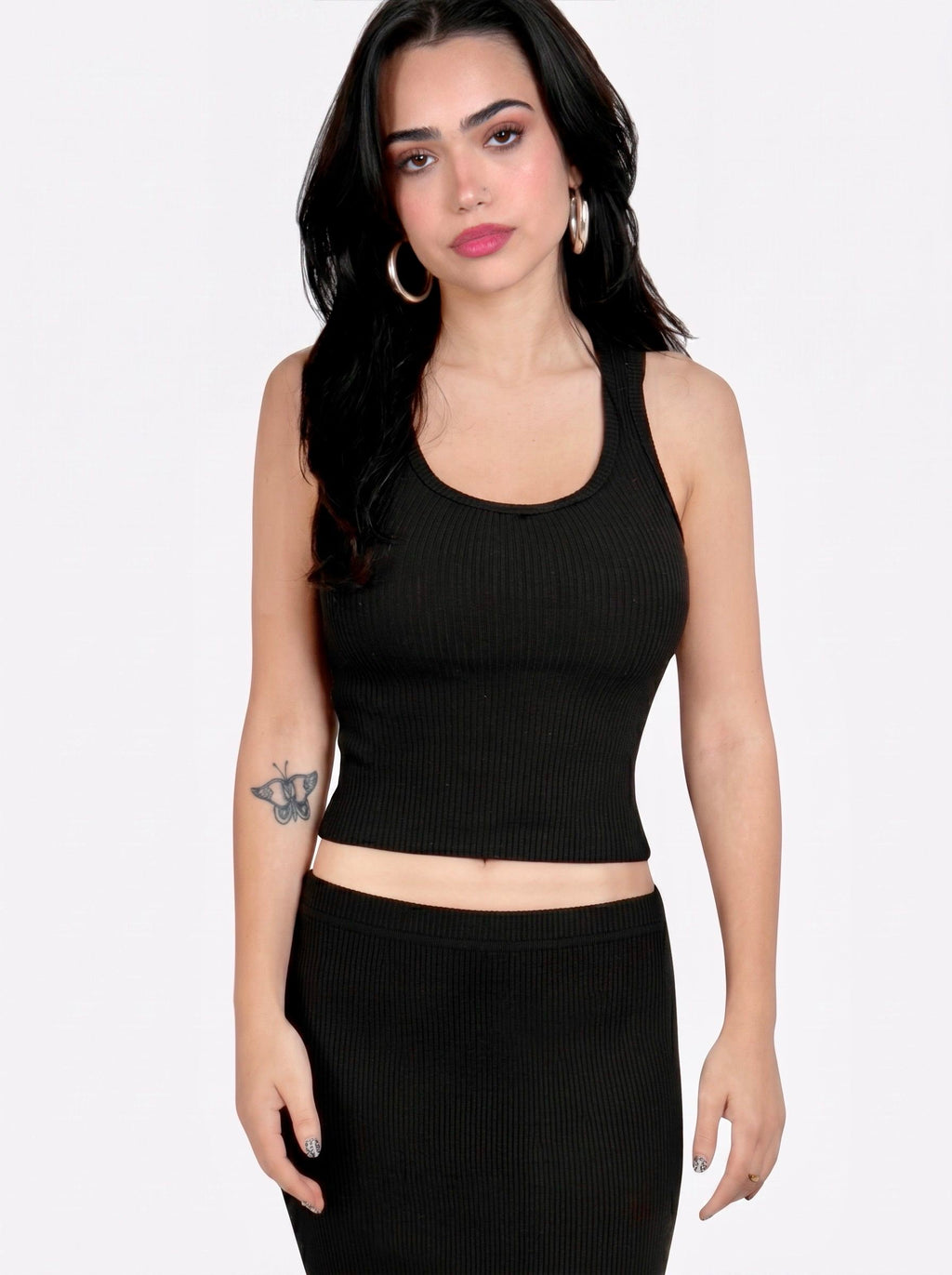 Woman wearing matching black rib knit scoop neck tank and pencil skirt by TKHLA 