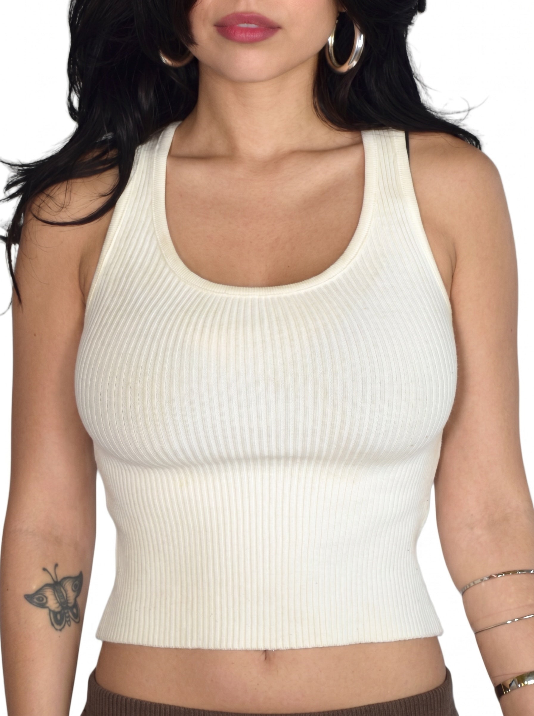 Close up of person wearing white rib knit scoop neck tank by TKHLA 