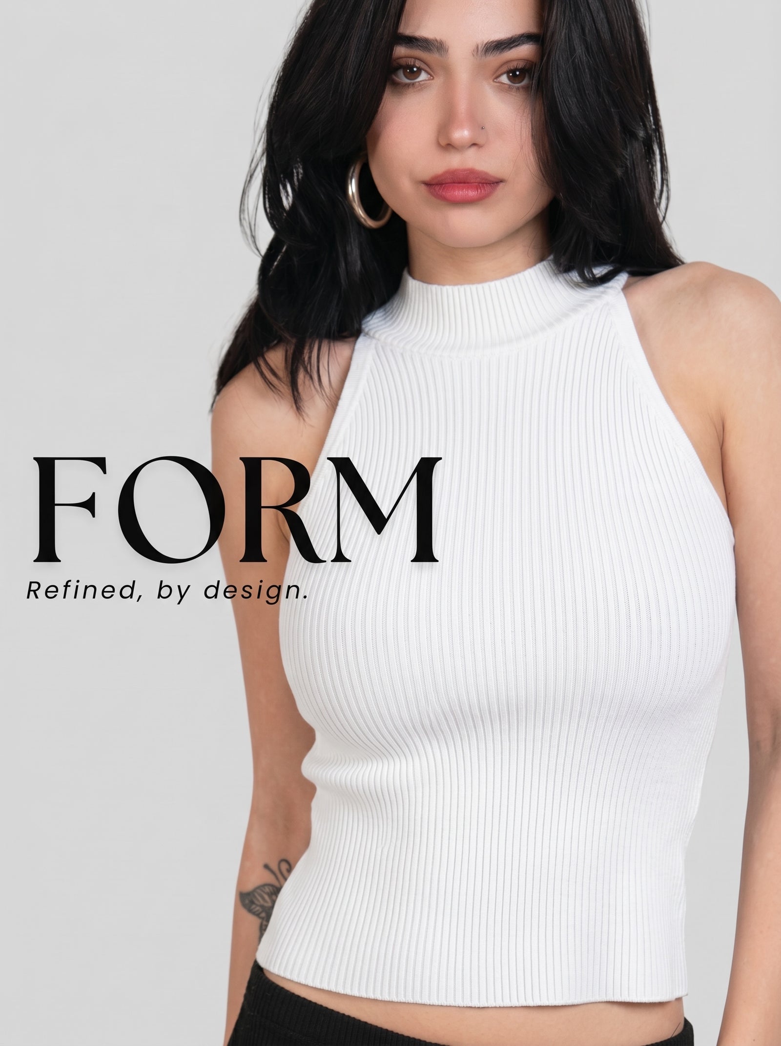 A woman wearing a white ribbed halter crop top with a mock neck, shown against a light gray studio background with the text 'FORM Refined, by design.' overlaid on the left side.