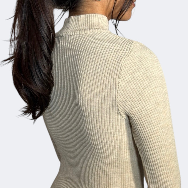 Drift Beige turtleneck sweater worn by a person with a neutral background