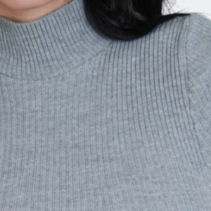 Gray ribbed knit top worn by a person on a white background