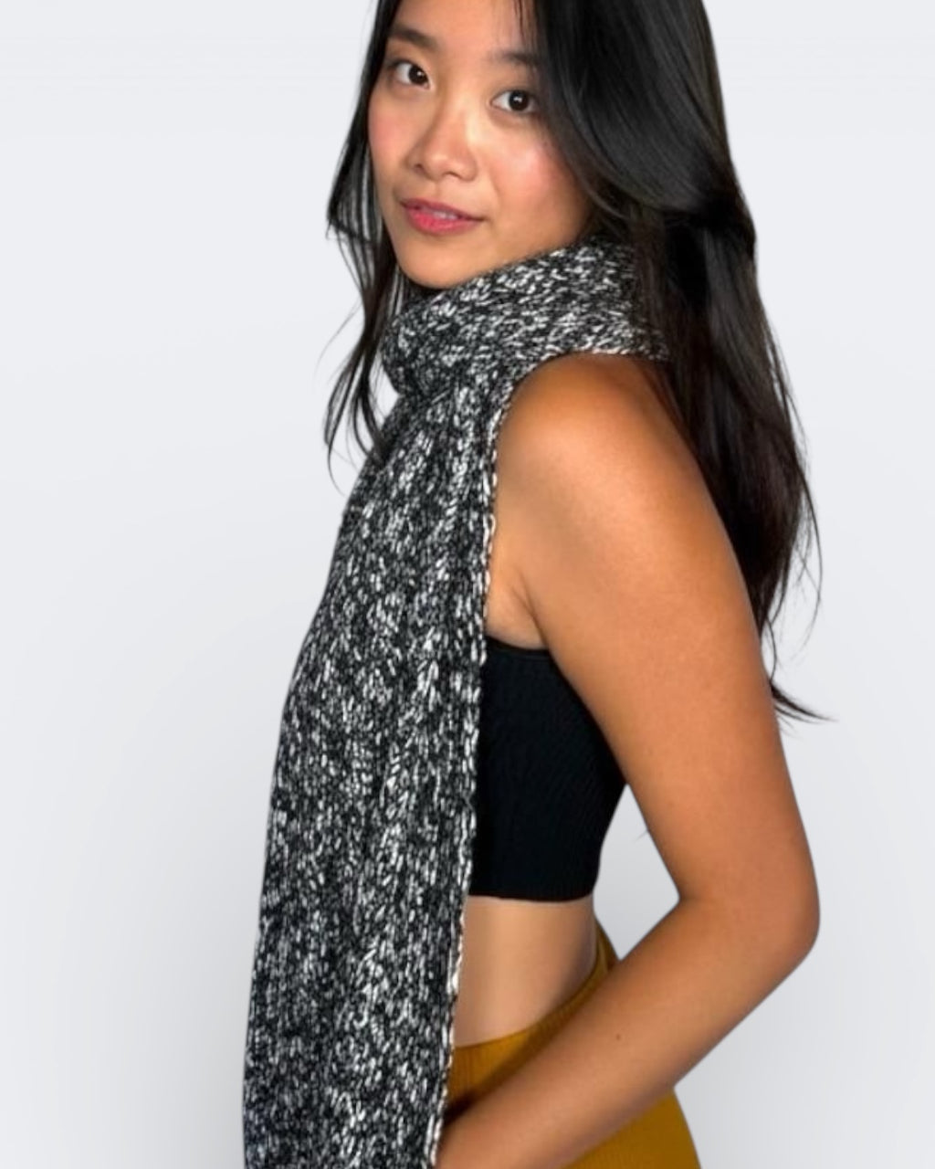 Woman wearing a black and white pattern scarf by The Knit House LA.