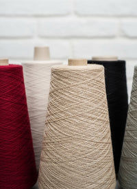 Spools of yarn in various colors on a white background