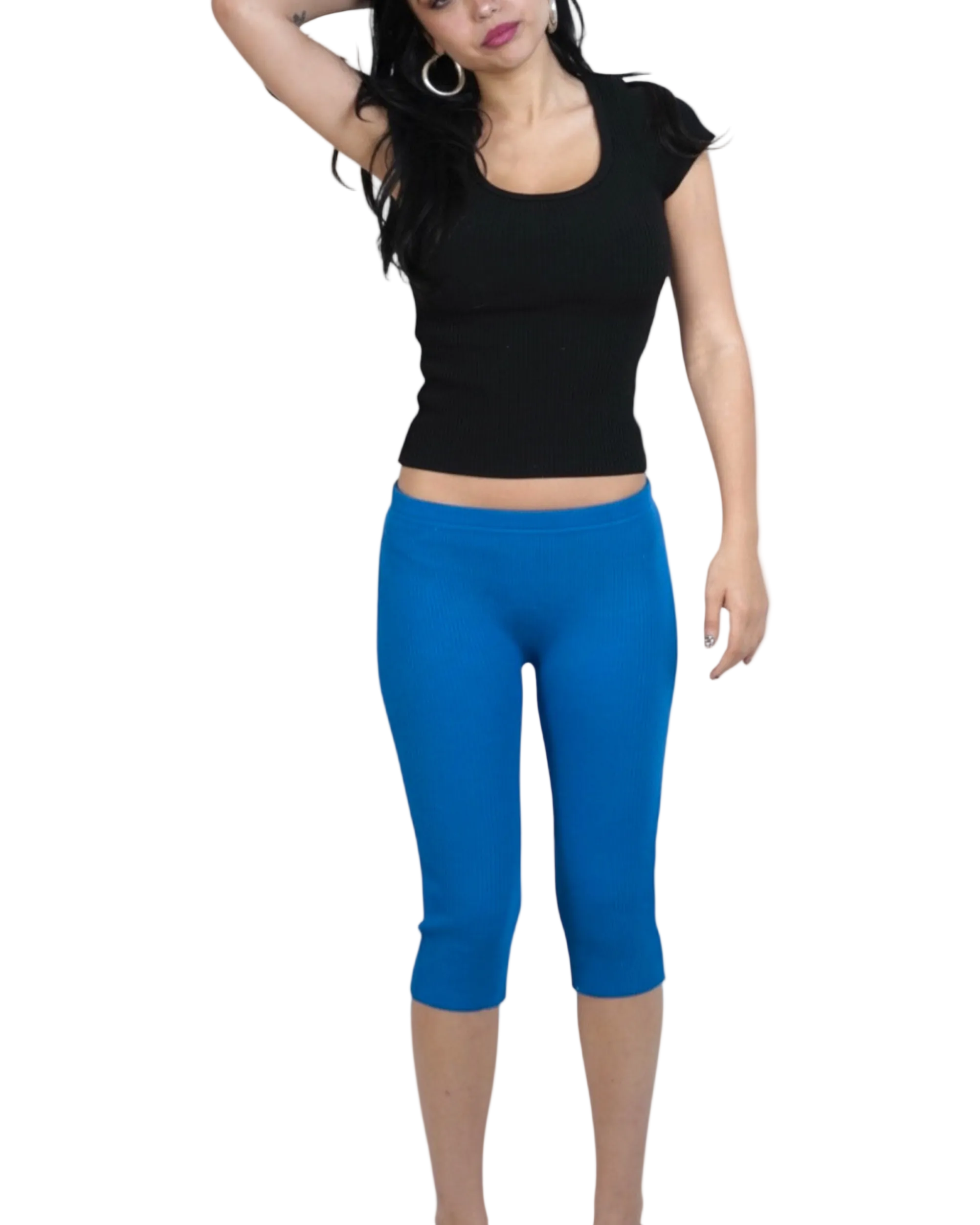 Woman wearing a black top and cobalt blue capri leggings on a white background
