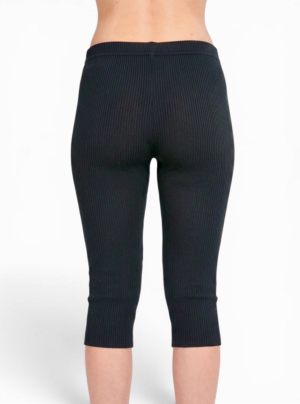 Back view of person wearing black rib knit Capris by TKHLA 