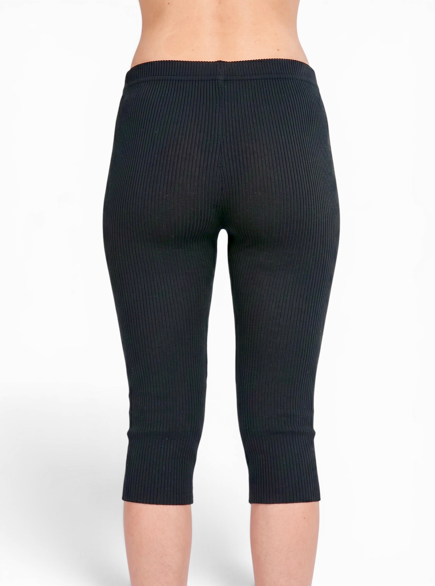 Back view of person wearing black rib knit Capris by TKHLA 